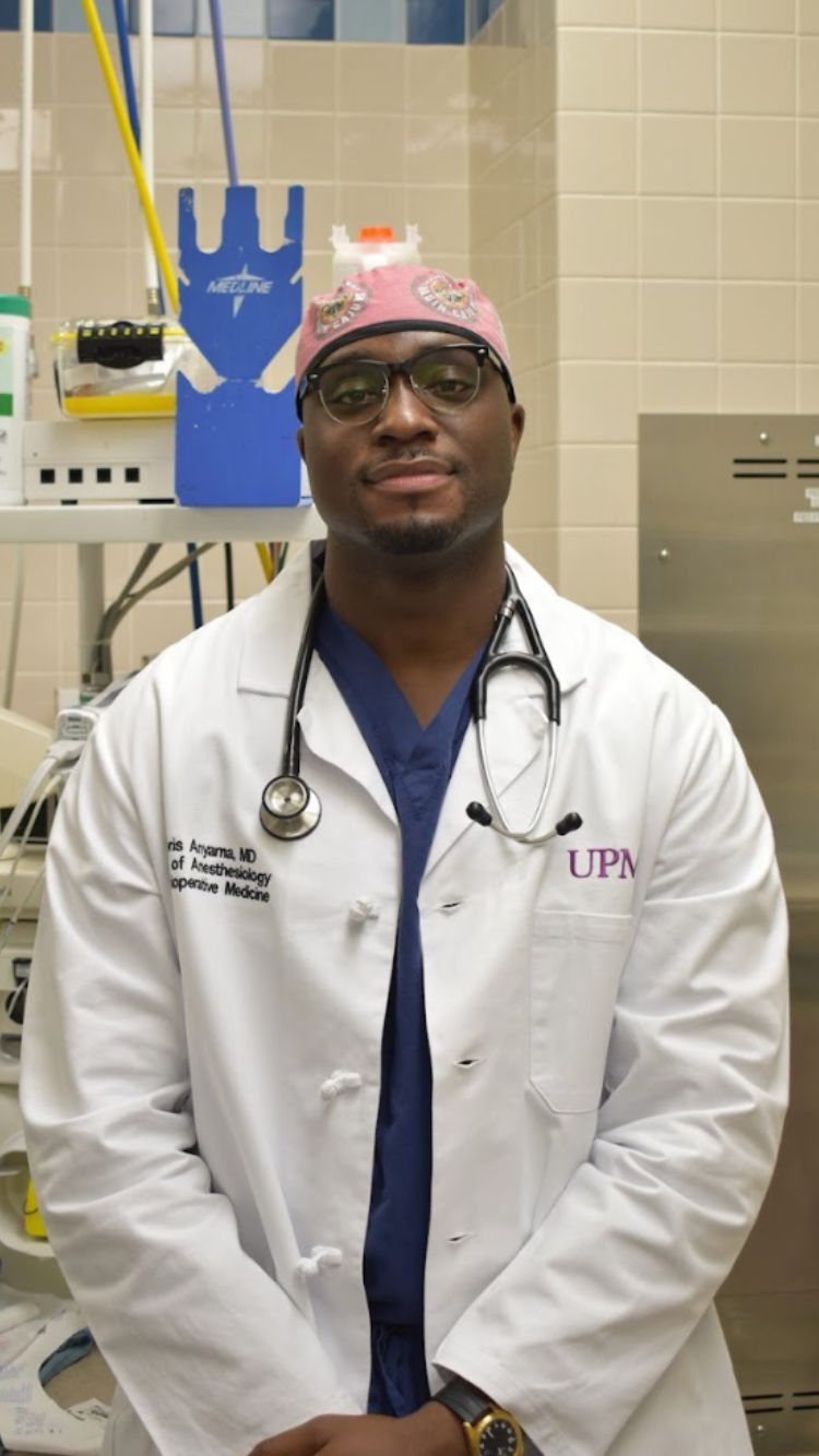 Boris Anyama in clinical attire inside an operating room.